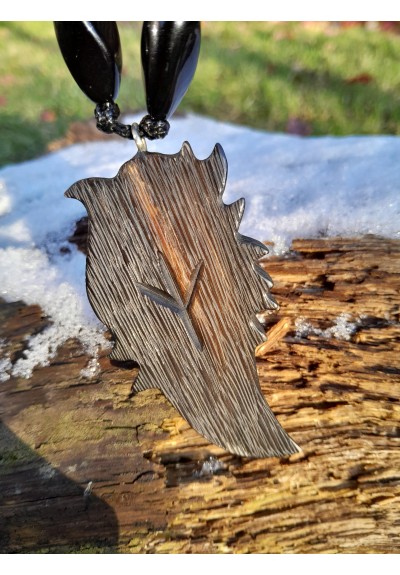 Hand-carved Viking black raven amulet with green eye.