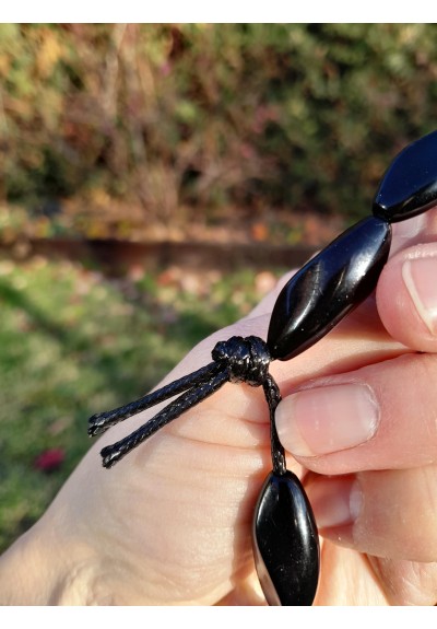 Hand-carved Viking black raven amulet with green eye.