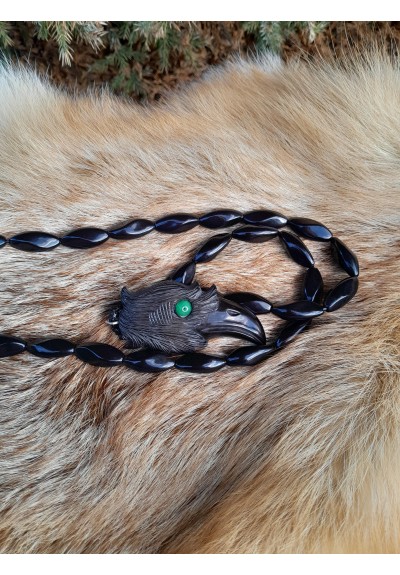 Hand-carved Viking black raven amulet with green eye.
