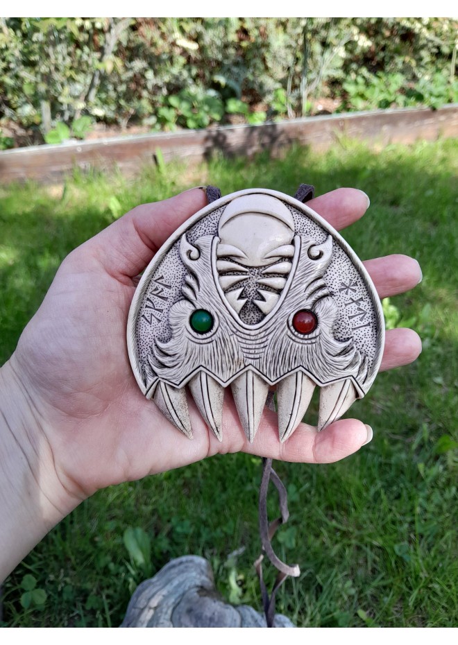 Double Wolf head with green and red eye. Carved Odin’s face