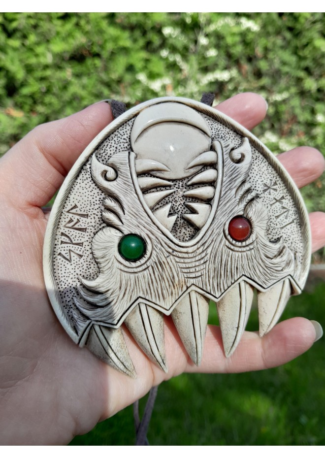 Double Wolf head with green and red eye. Carved Odin’s face