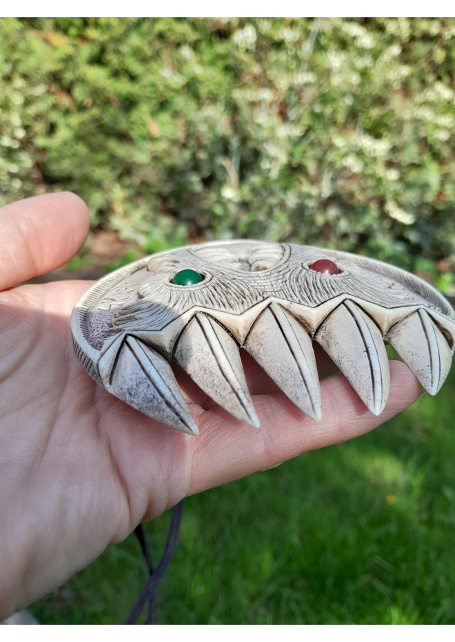 Double Wolf head with green and red eye. Carved Odin’s face