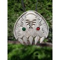 Double Wolf head with green and red eye. Carved Odin’s face