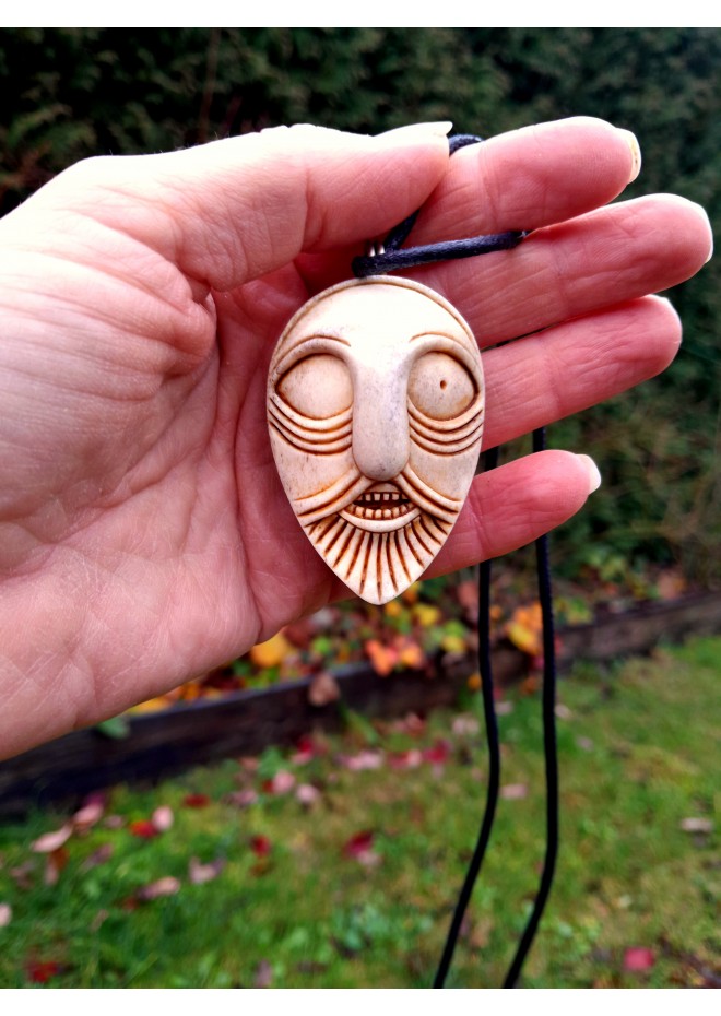 Handcrafted moose antler amulet featuring Odin and runes