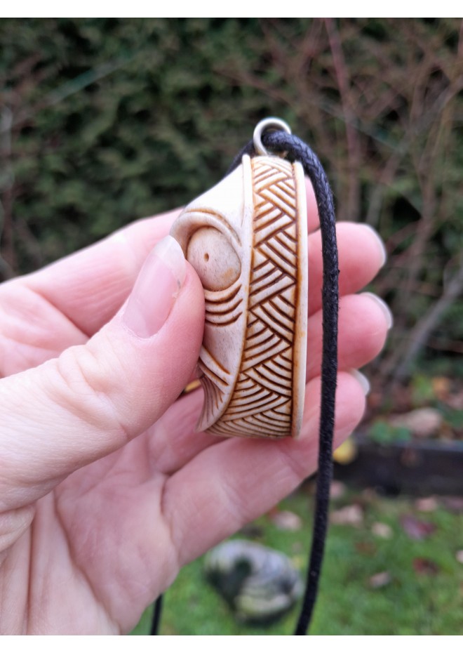 Handcrafted moose antler amulet featuring Odin and runes