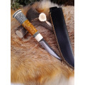 Handmade Finnish Puukko knife with master engraving and leather sheath. Hand-forged blade. Antler and stabilized maple burl handle.